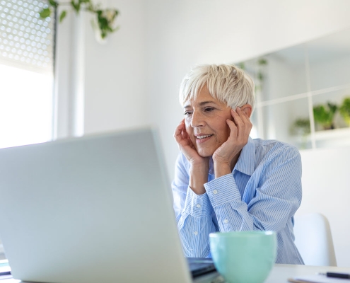 portrait casual woman using her laptop while sitting home office working attractive middle aged businesswoman sitting front laptop managing her small business from home