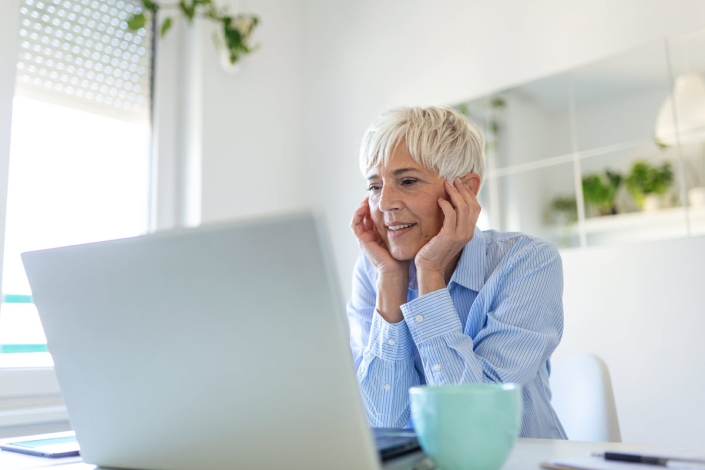 portrait casual woman using her laptop while sitting home office working attractive middle aged businesswoman sitting front laptop managing her small business from home